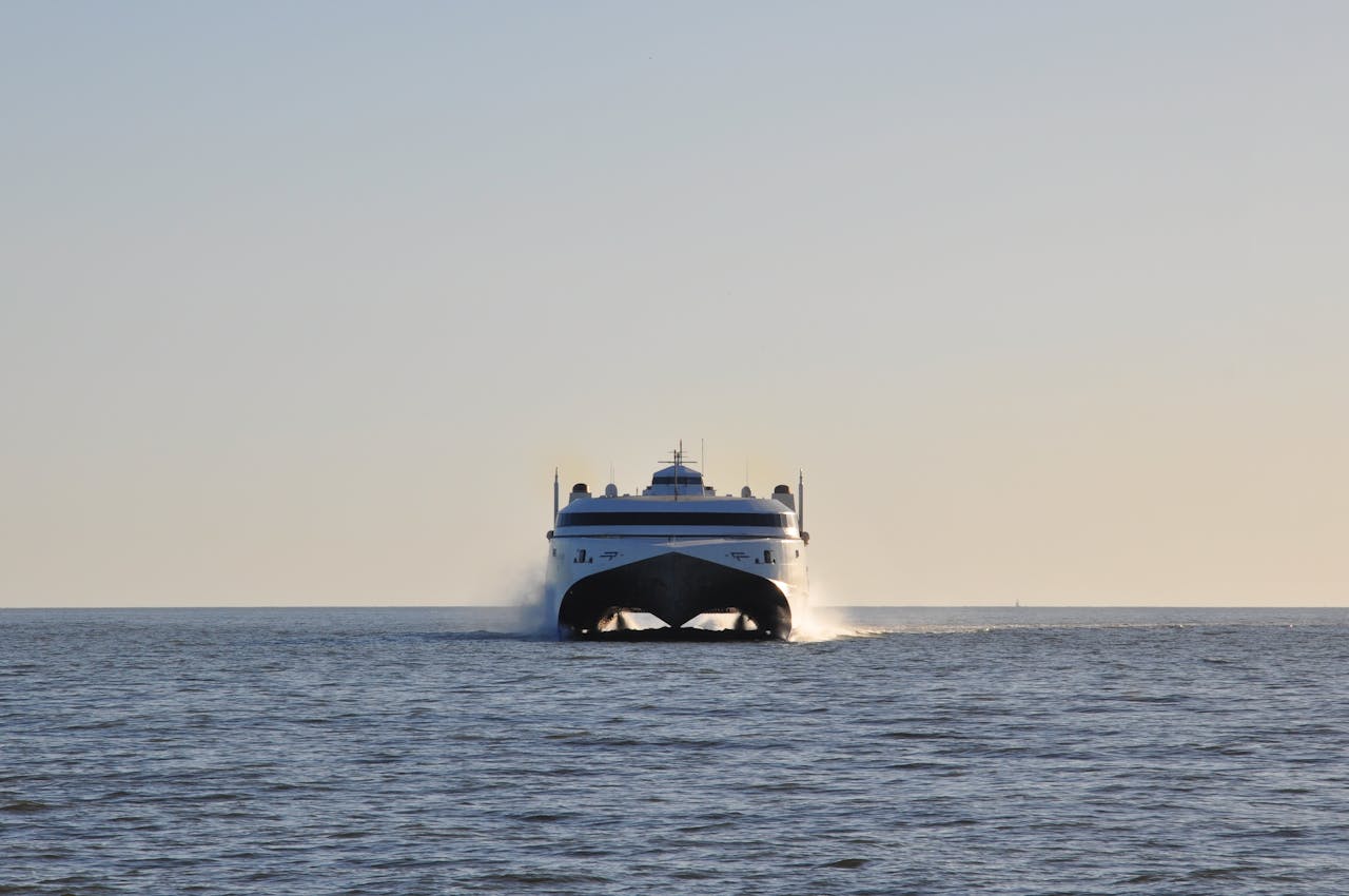 A high-speed ferry travels across the calm waters off Montevideo, Uruguay, during the day.